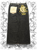 Baggy cotton denim pants with golden embroidery details in a vintage Y2K streetwear style.