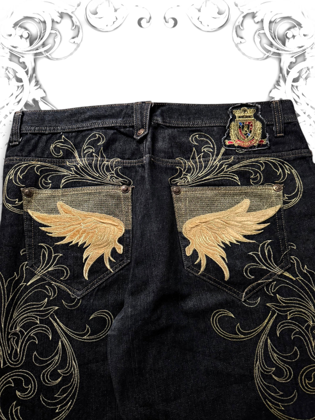 Crownholder Denim backpockets embroidered with golden wings and embellished with studs