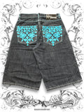 Blue Southpole wide-leg jorts with tribal embroidery and contrast stitching in a vintage Y2K denim style.