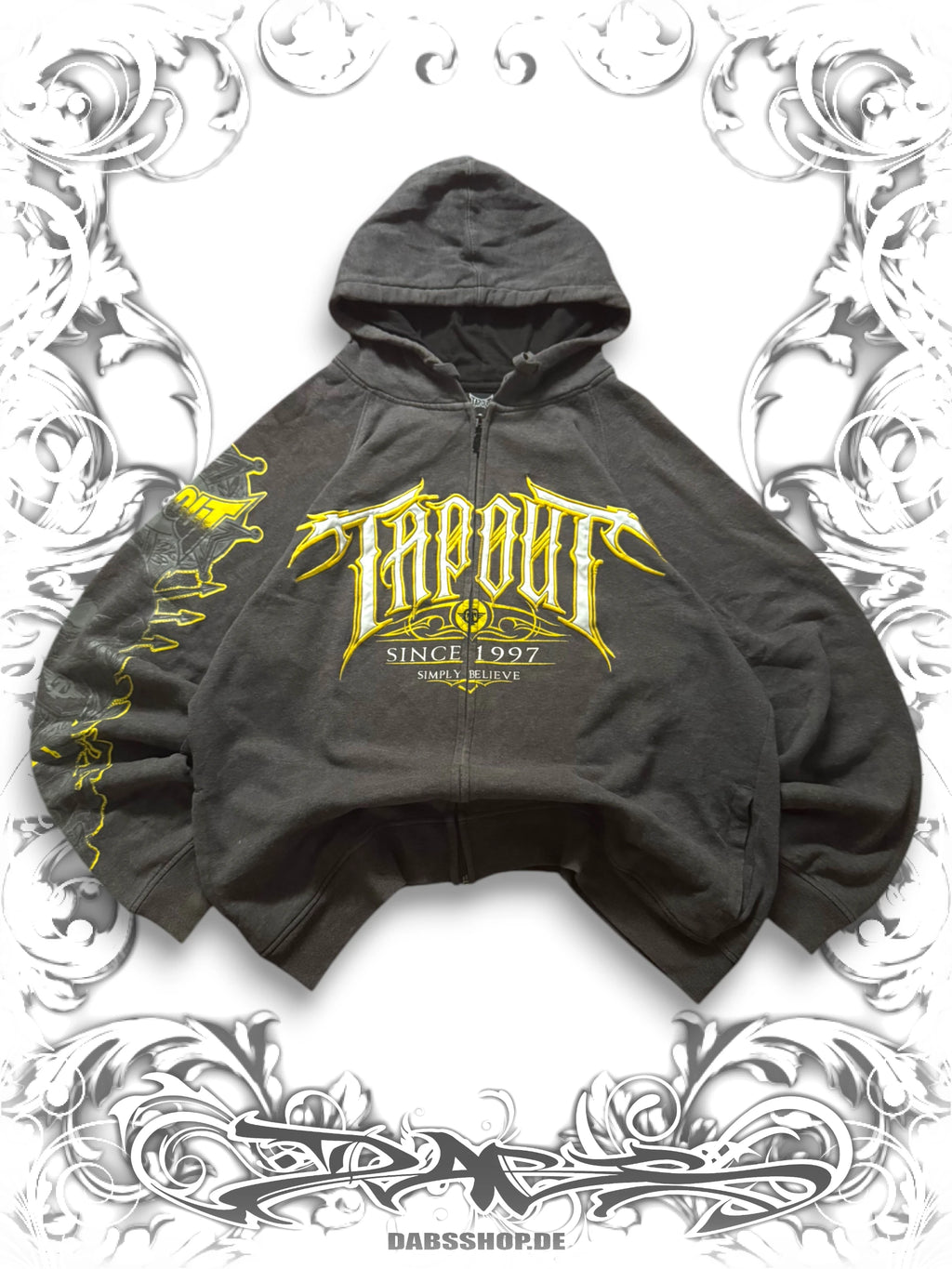 Oversized grey Tapout "Simply Believe" zip hoodie with bold graphic print and embroidered details in a Y2K streetwear style.